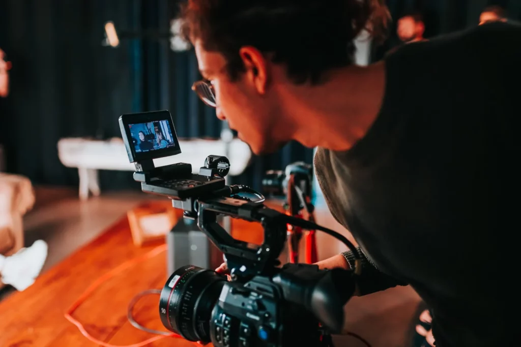 videographer filming a commercial acting scene on a professional video camera